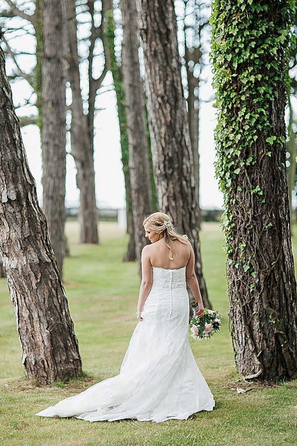 bride looking on the side in teh gardens