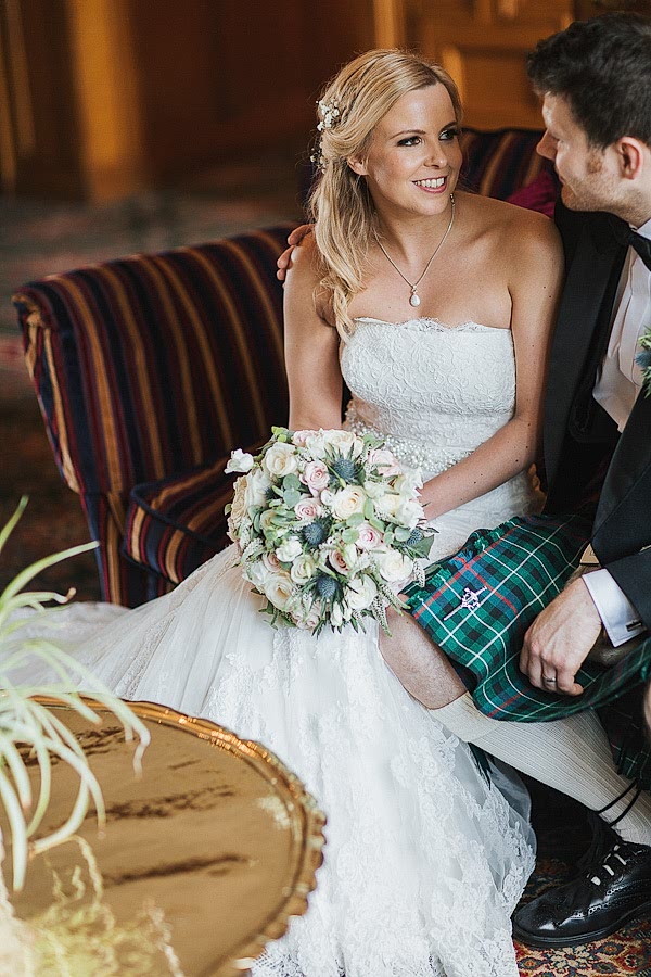 bride and groom sitting inside lochgreen hotel