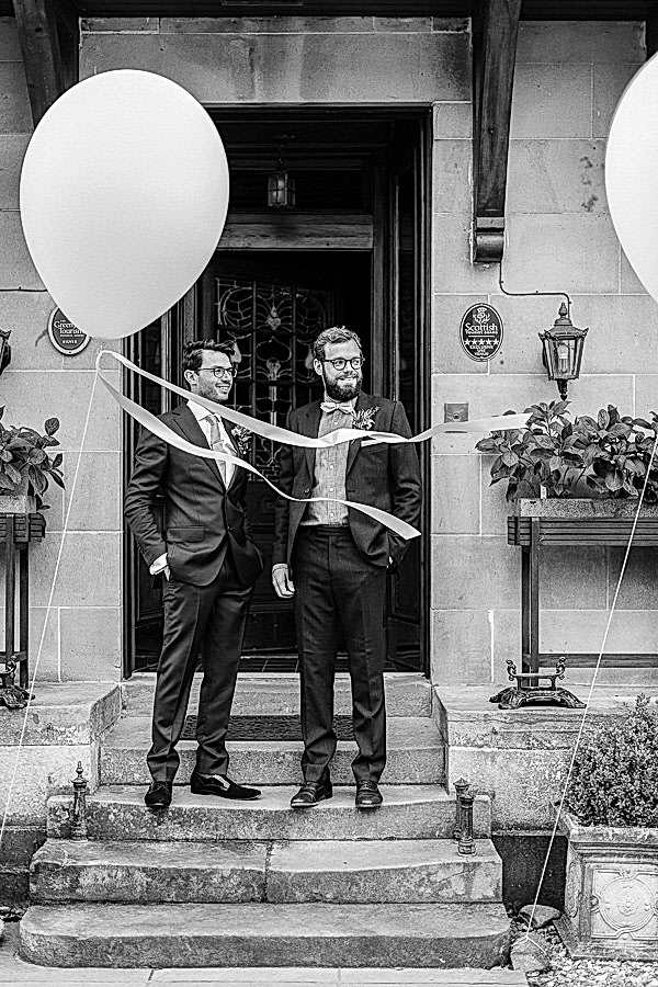 groom and bestman outside of the lodge on loch goil