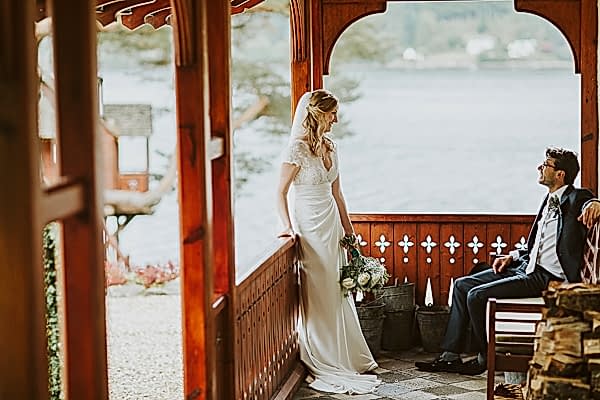 newlyweds looking at each other at the lodge on loch goil in scotland
