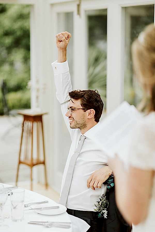 groom with fist raised