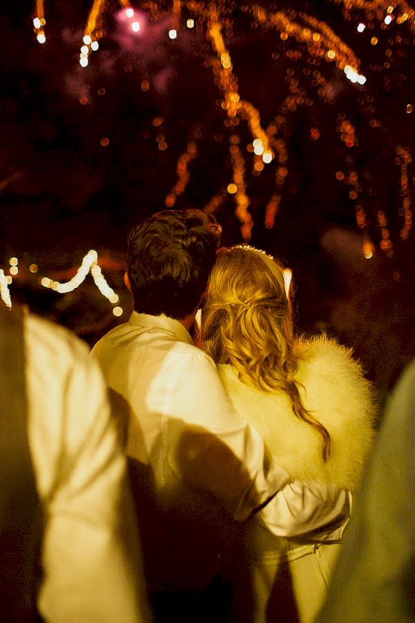 newlyweds embraced looking at fireworks display during their wedding at the lodge on loch goil in scotland