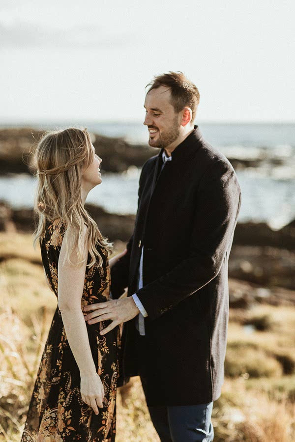 A couple on a beach having their engagement photos taken