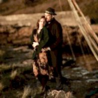 engagement photos in scotland two people huging in an old harbour in scotland