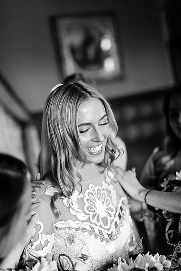 bridesmates huging bride