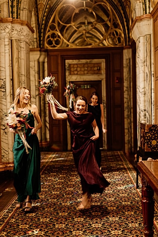 bridesmates dancing while walking to the ceremony