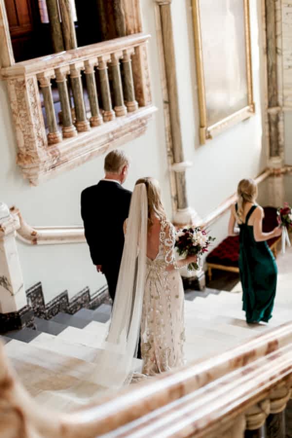 bride with father walking down teh stairs at mount stuart