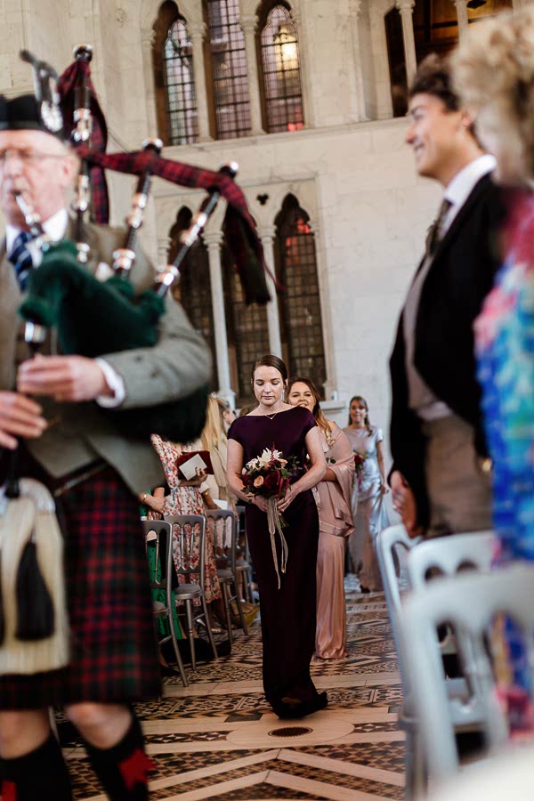 bridesmates led by piper wlaking down the aisle white chapel mount stuart
