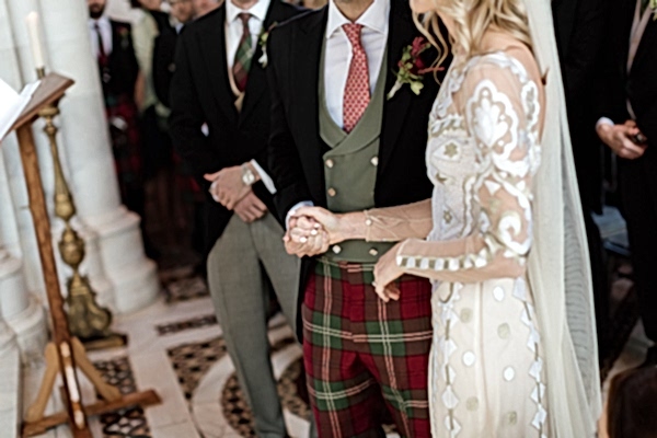 bride and groom holding hands during liturgy