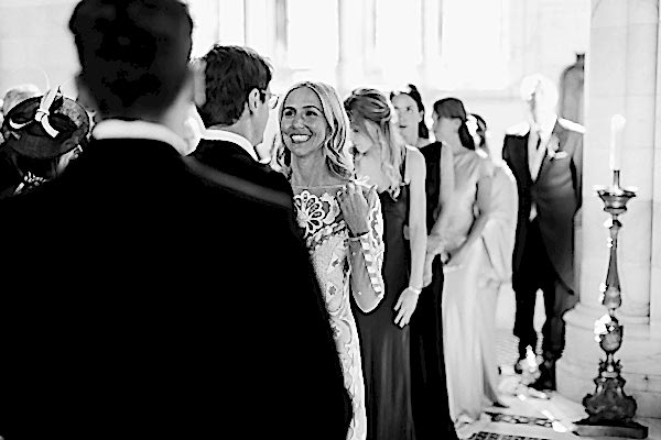 bride smiling at groom during scottish mass