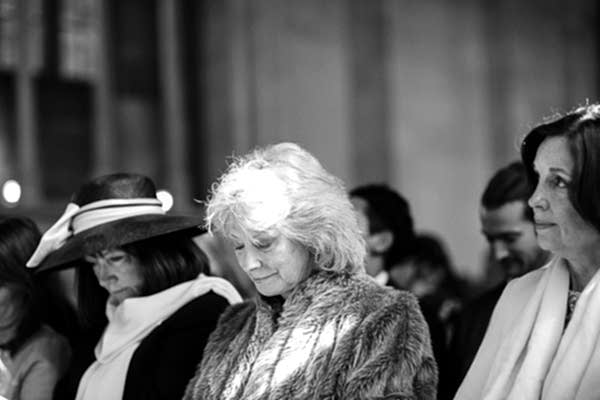 wedding guests praying 