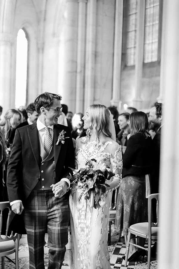 bride and groom looking at each other walking from ceremony