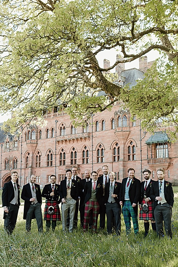 groomsmen posing together in tartan