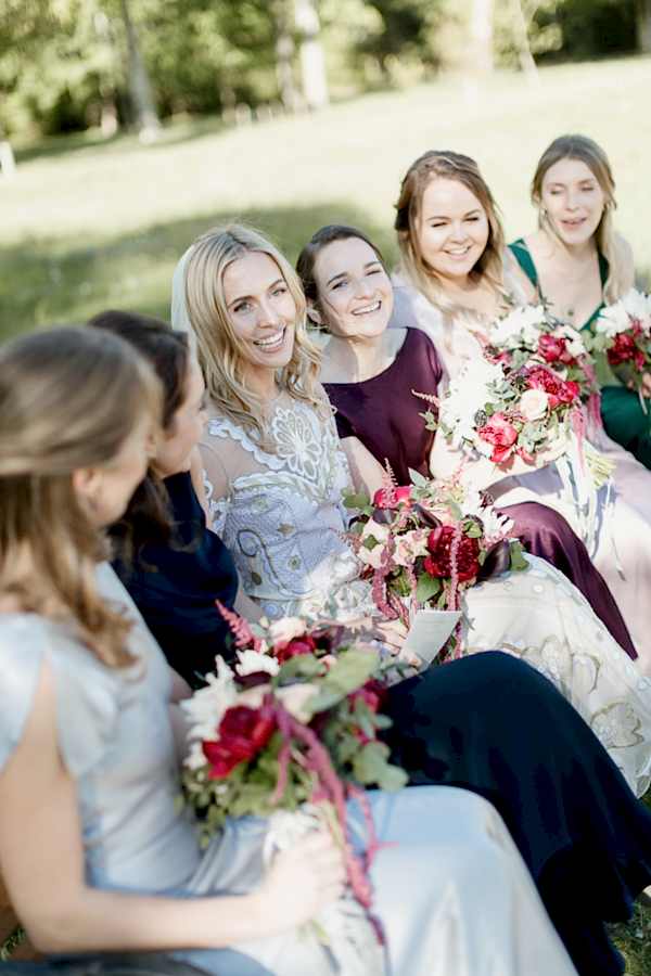 bride with friends sitting on a bench