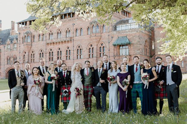 bridal party posing for a picture in scotland