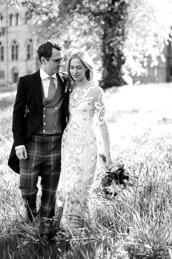 bride and groom walking in teh garden in scotland