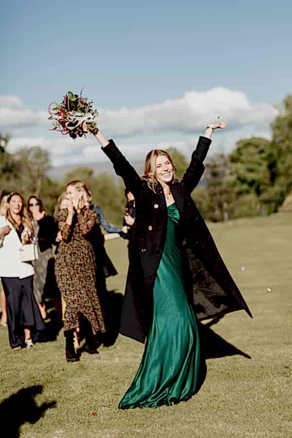 bridesmate catches flowers after tossing