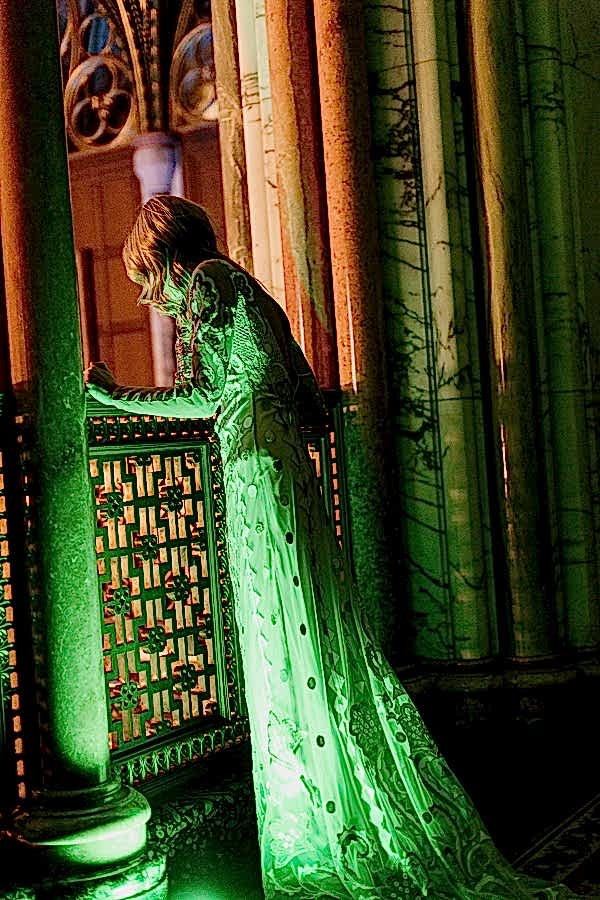 bride looking down on thier guests from gallery