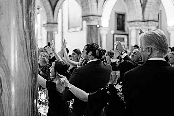 guests clapping and cheering seeing bride and groom