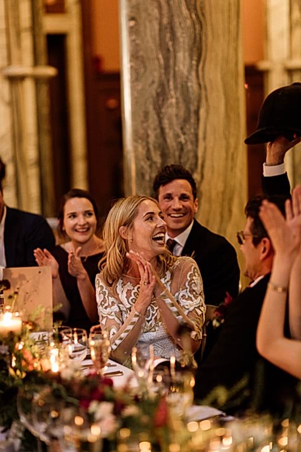 bride and groom laughing at speeches 
