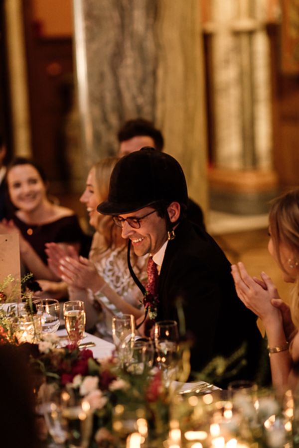 groom is wearing jockey hat at speeches