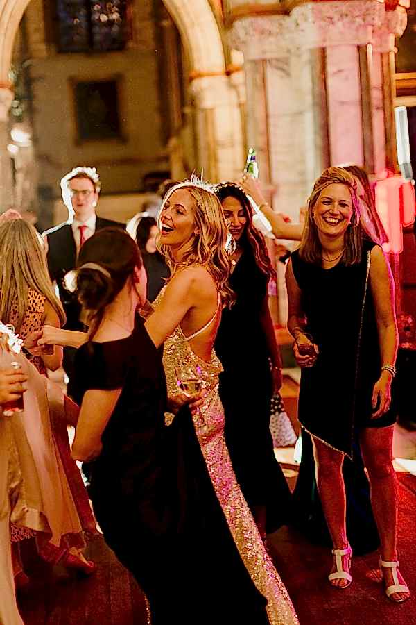 girls smiling and dancing at wedding