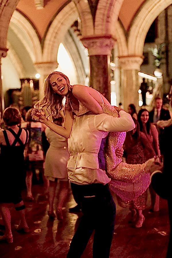bride beeing picked up by grooman during dancing