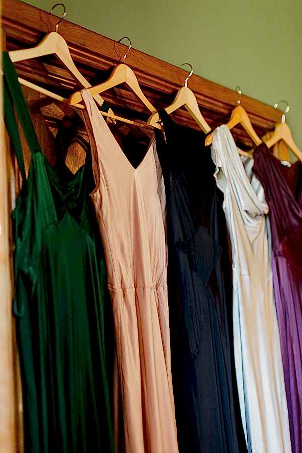 bridesmates dresses multicolour hanging on door