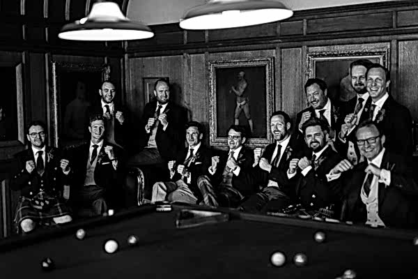 groom making boxing gestures posing for a photo scotland