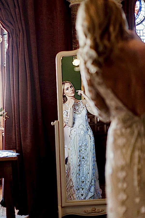 bride getting ready at mount stuart looking in the mirror