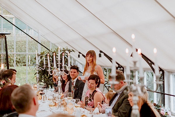 Sister speeking at the wedding inside a Glenapp Greenhouse