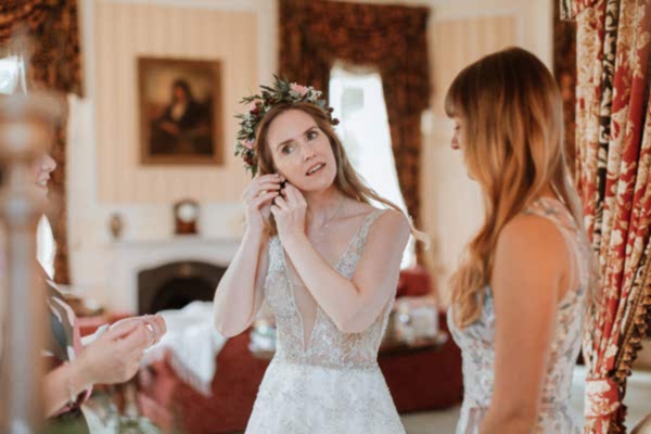 bride trying her earings at Glenapp Castle Ayrshire 