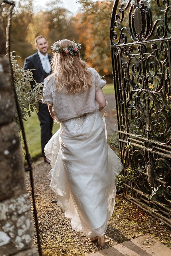 bride waking through a gate of Glenapp Estate