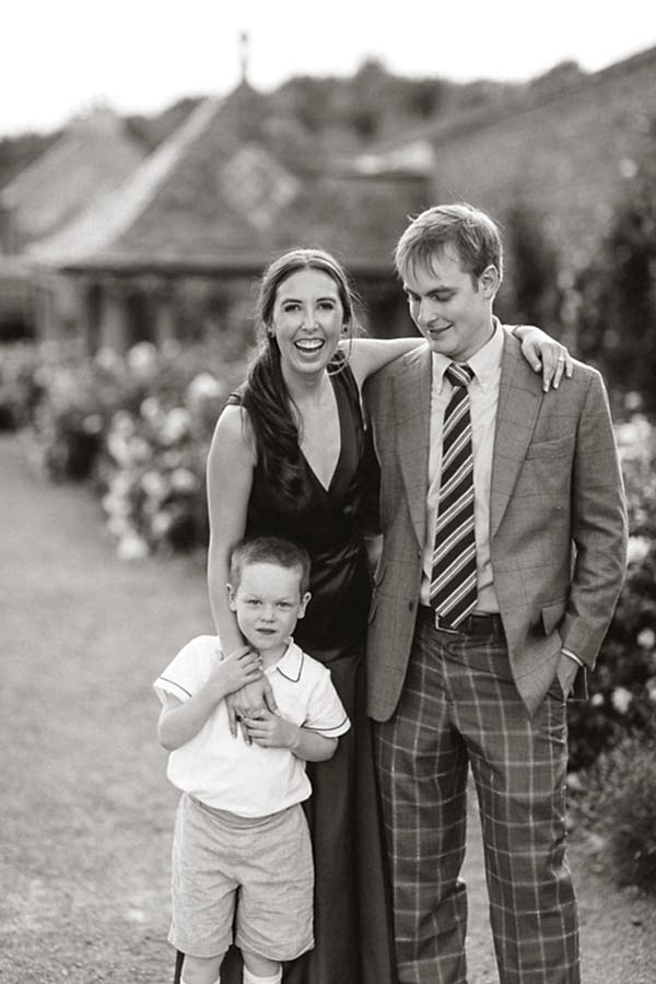 bride and groom to be with page boy in the garden