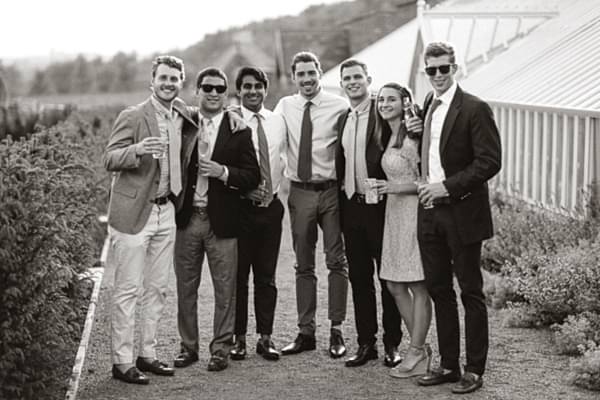 wedding guests with drinks in the garden