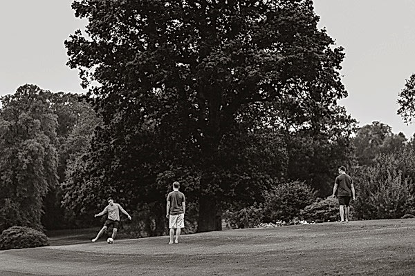 groom playing footbal before wedding soarn castle