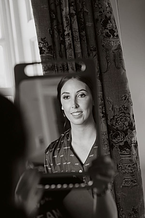 bride looking at herslef in teh mirror