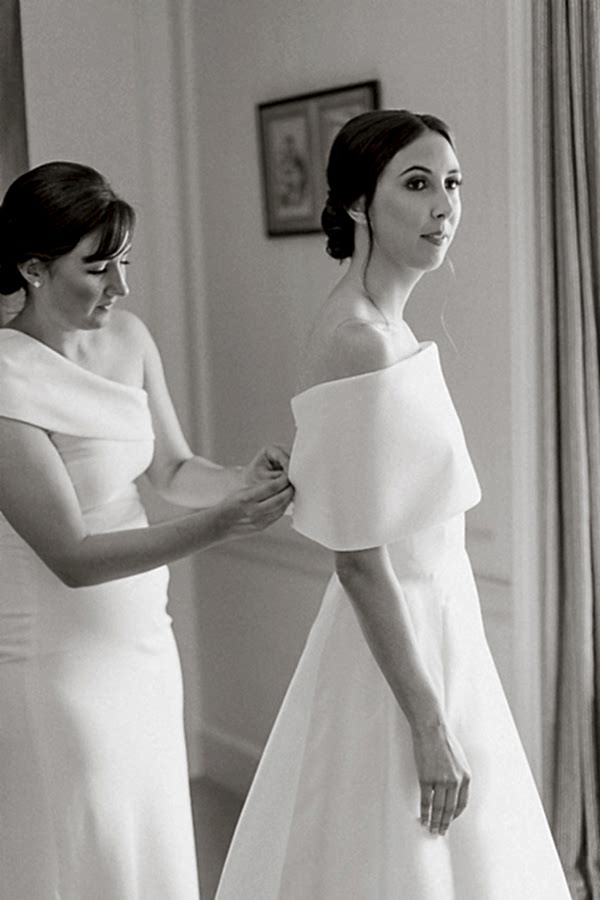 bride having her dress fixed