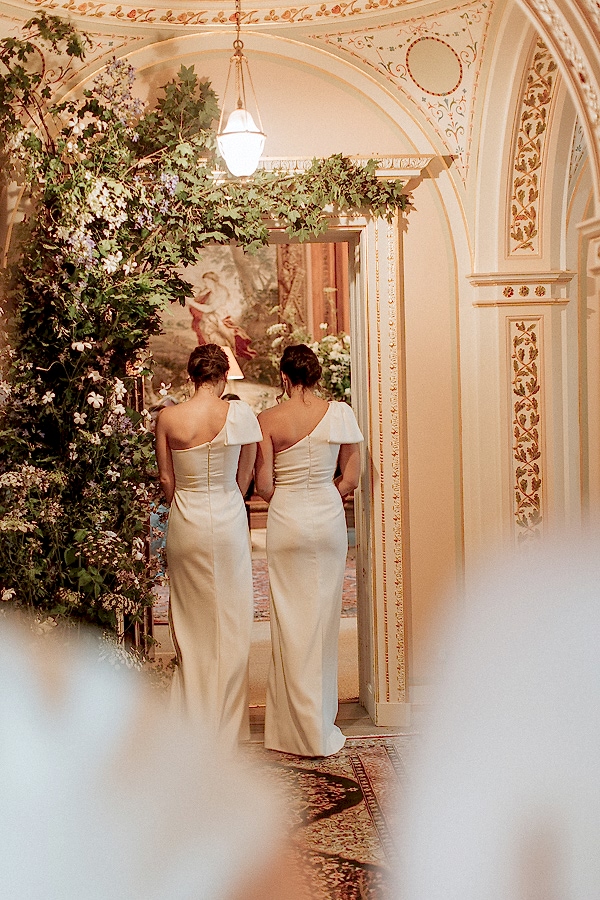 bridesmates walking down into tapestry room